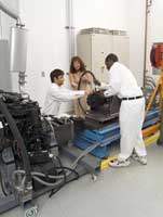 Monika Ivantysynova (center), the Purdue Maha Professor of Fluid Power Systems, works in her lab with Edat Kaya (left), a lab engineer, and Donnell Cunningham, a student from the Summer Undergraduate Research Program. Ivantysynova, director of the university