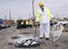 Colonel Sanders Look-alike Bob Thompson helps a repair crew in Louisville 