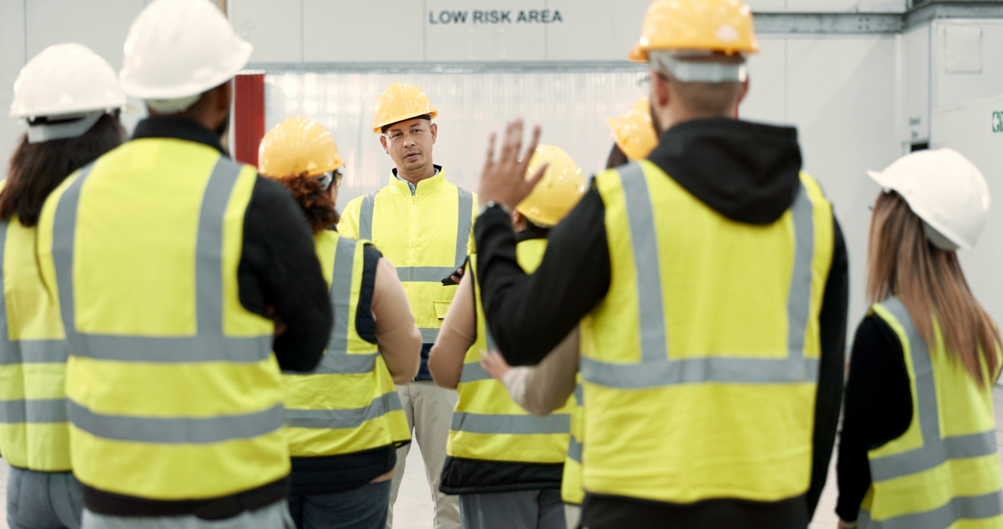 Construction site, meeting and people in discussion for planning, maintenance and renovation in building.