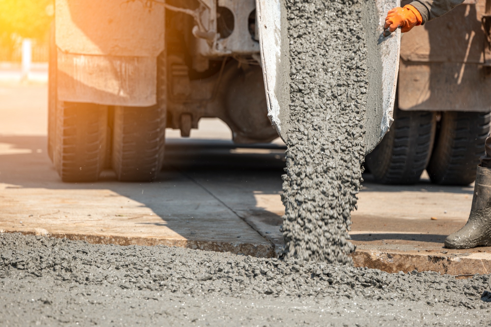 Pouring ready-mixed concrete after placing steel reinforcement to make the road by mixing in construction site.