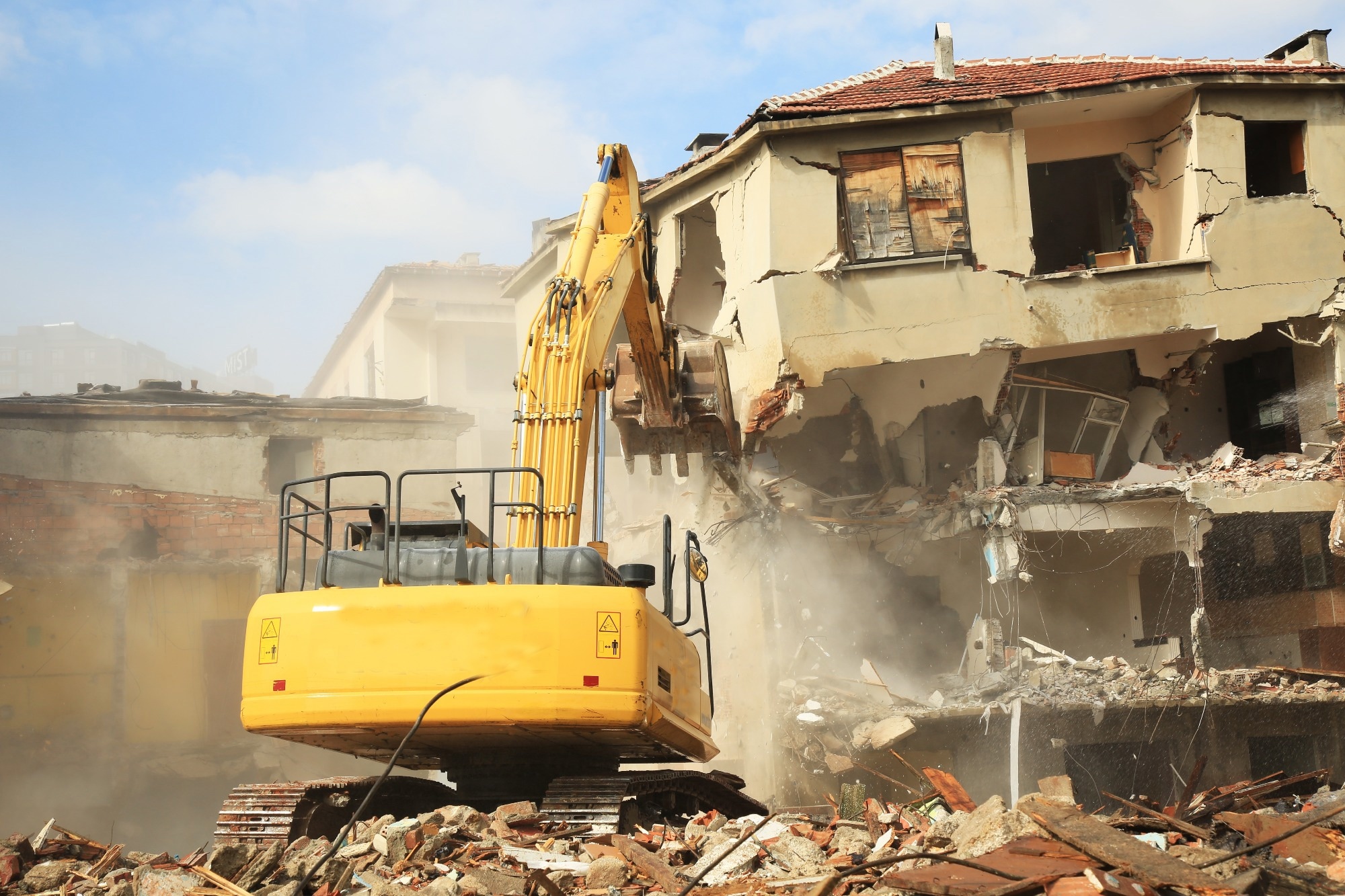 Construction machinery demolishing buildings.