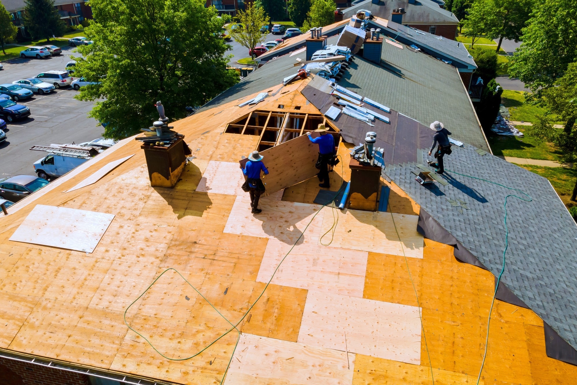 Replacing old asphalt bitumen shingles on house roof in order to repair roof.