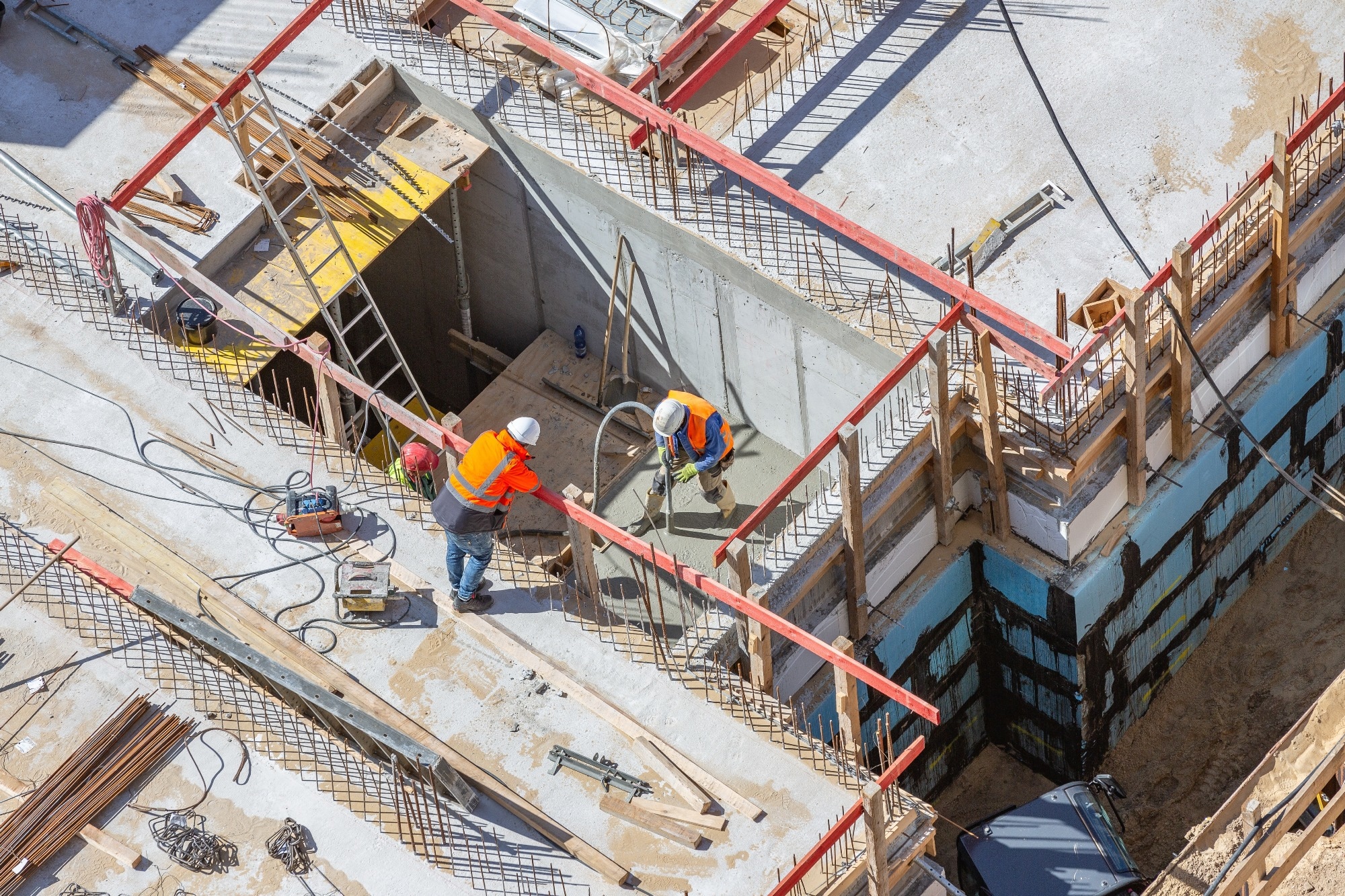 men on top of building site