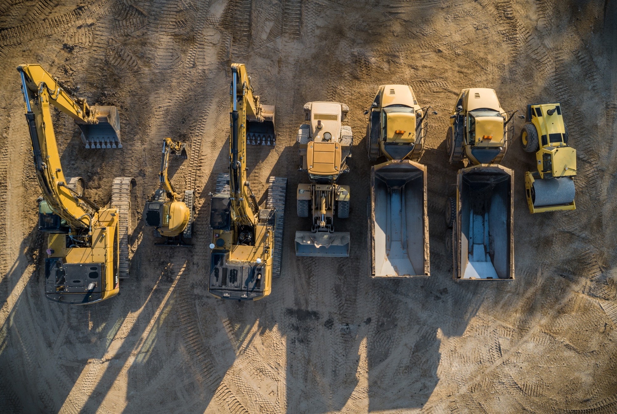 A fleet of construction equipment lined up.