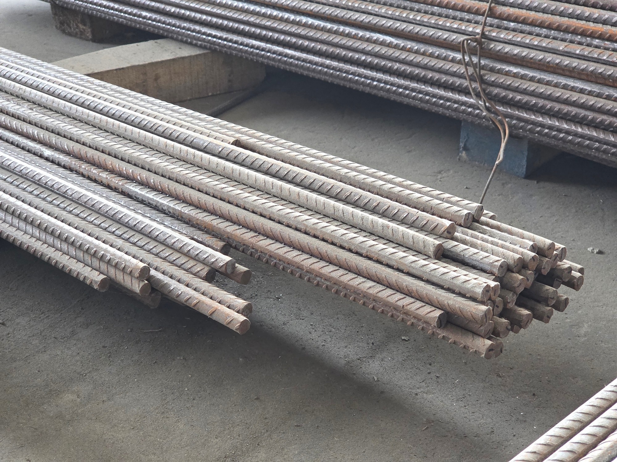 Bundle of rebar rods awaiting transport and installation in concrete works.