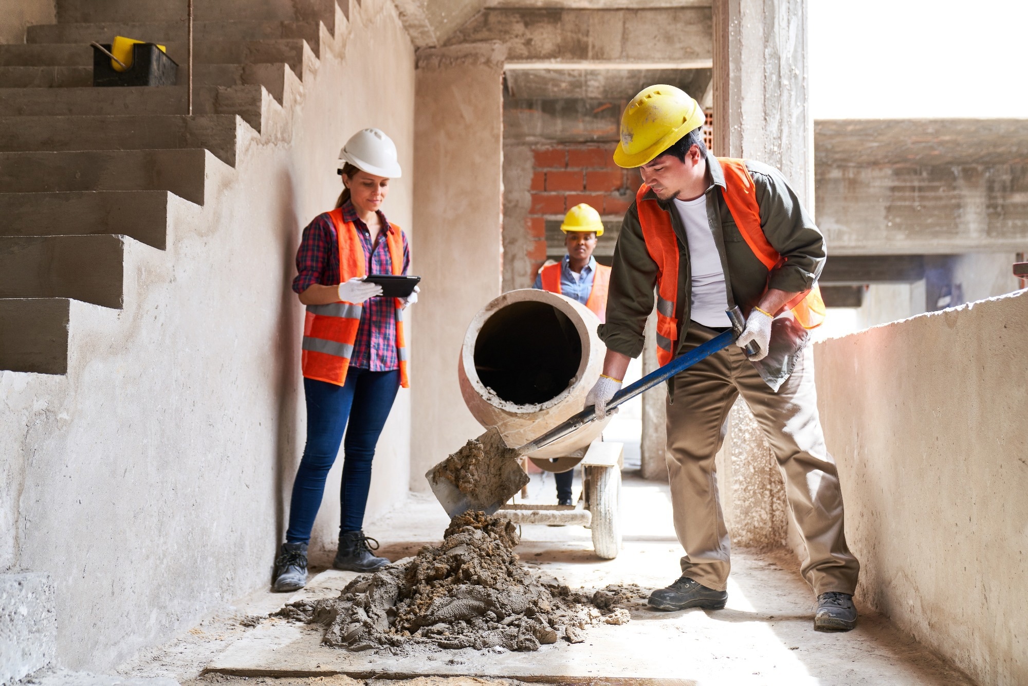 Masons mixing cement.