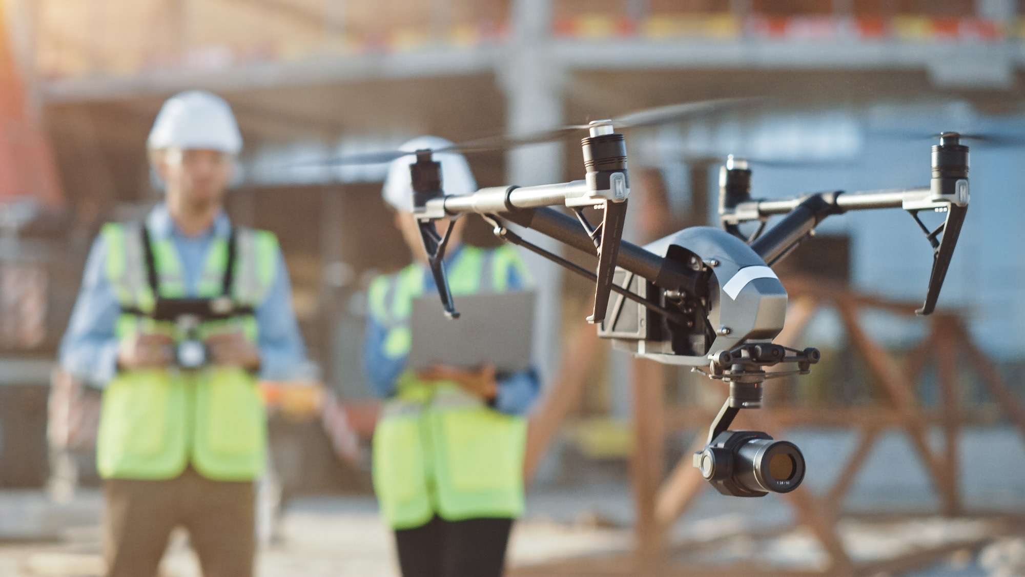 Two Specialists Use Drone on Construction Site.
