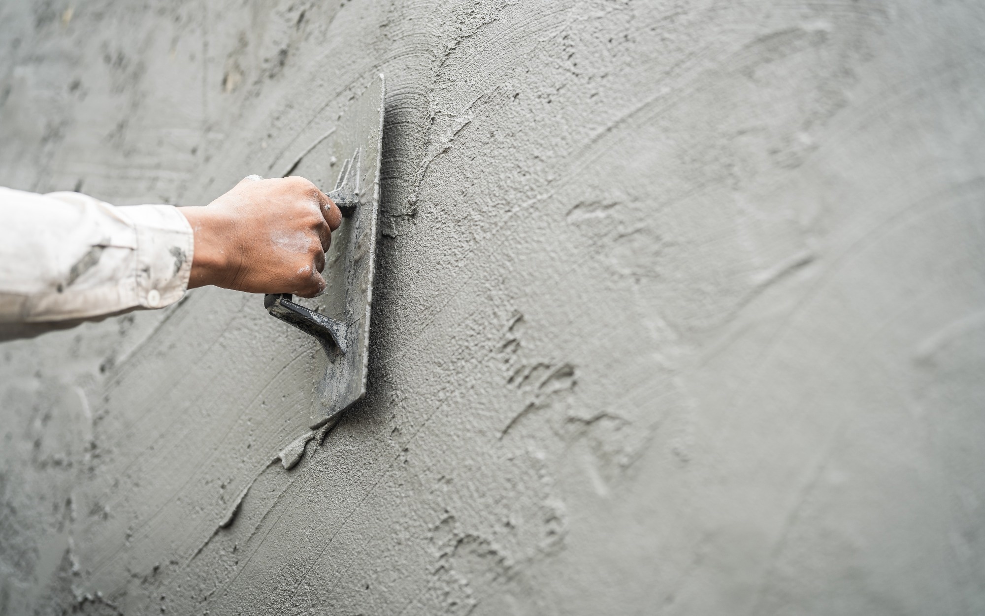 Worker, Hand plasterer plastering Cement wall.