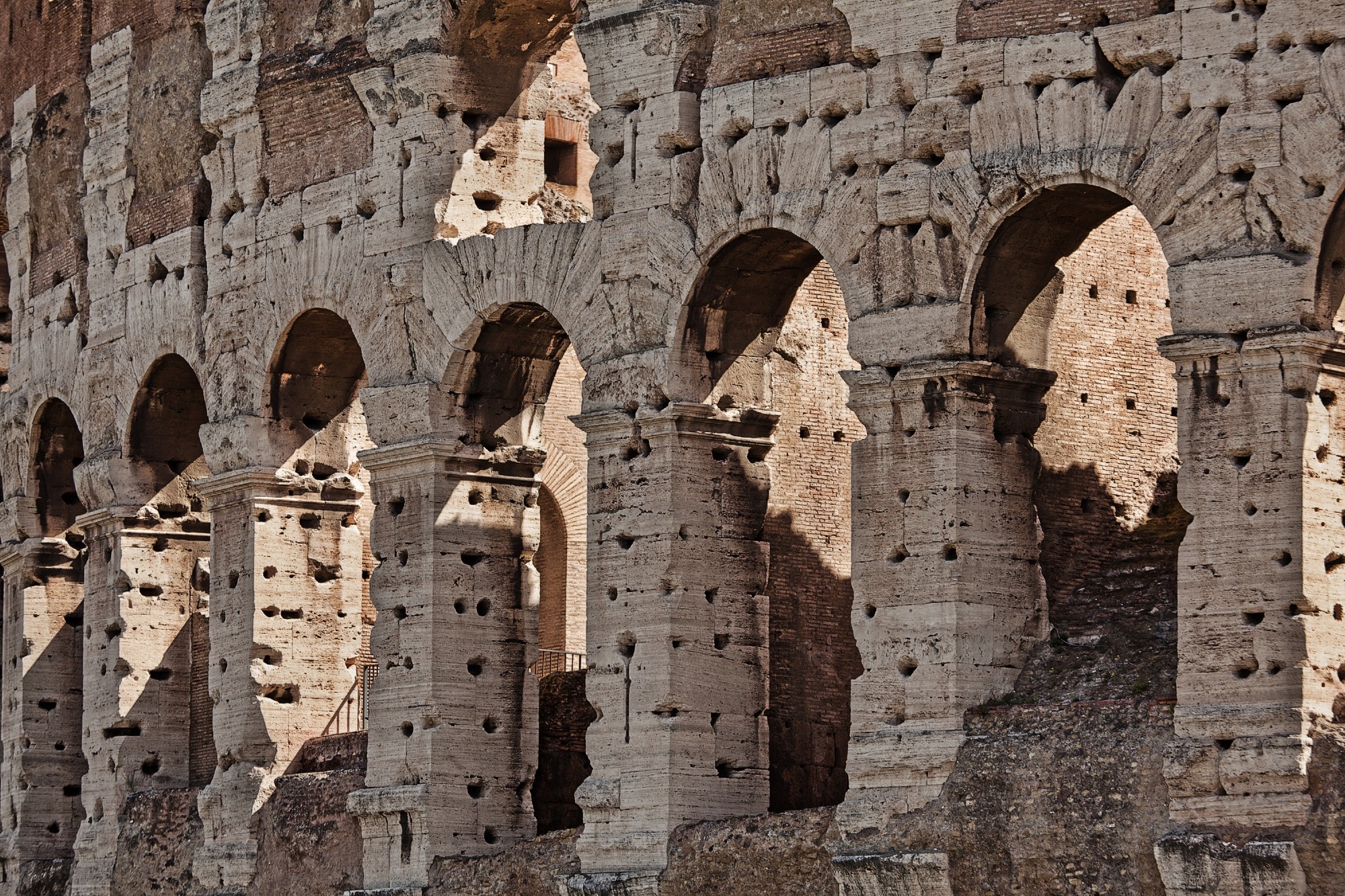 The Colosseum or Coliseum, is an elliptical amphitheatre in the centre of Rome, Italy. Built of concrete and stone, it is considered one of the greatest works of Roman architecture and engineering.