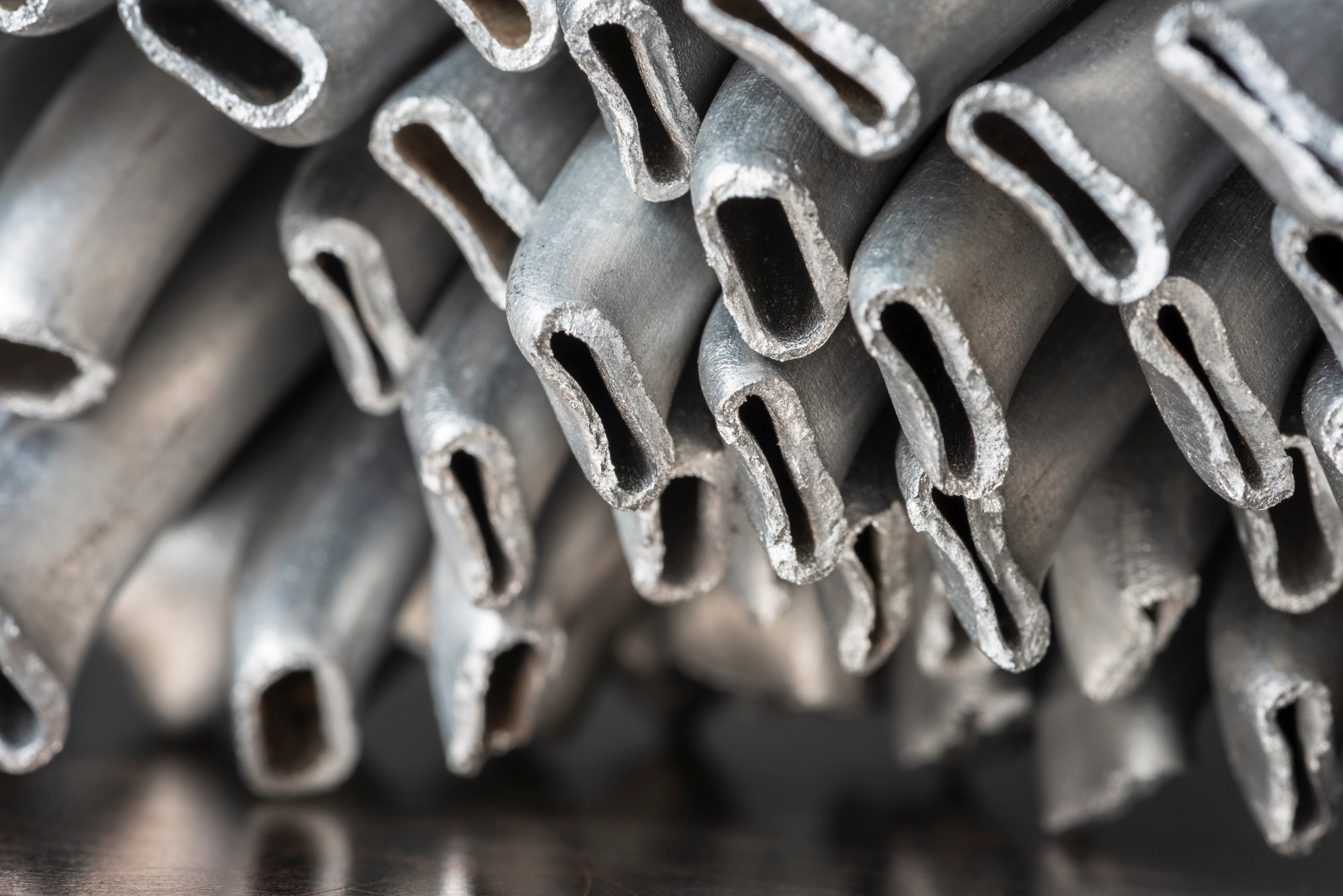 Close-up of crushed aluminum scrap, discarded metal ready for recycling at an industrial scrap yard.