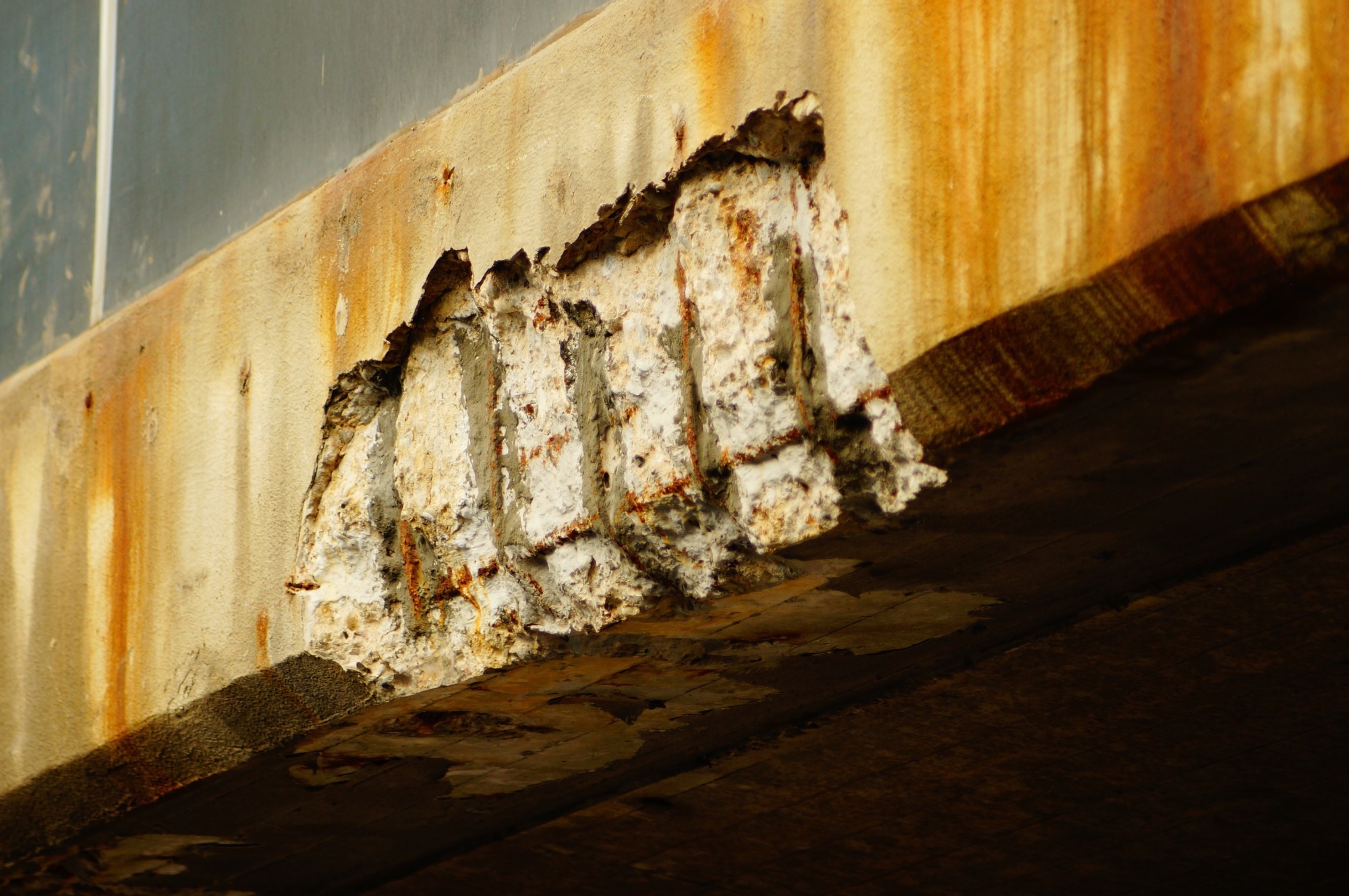 Steel corrosion damage on a concrete bridge.