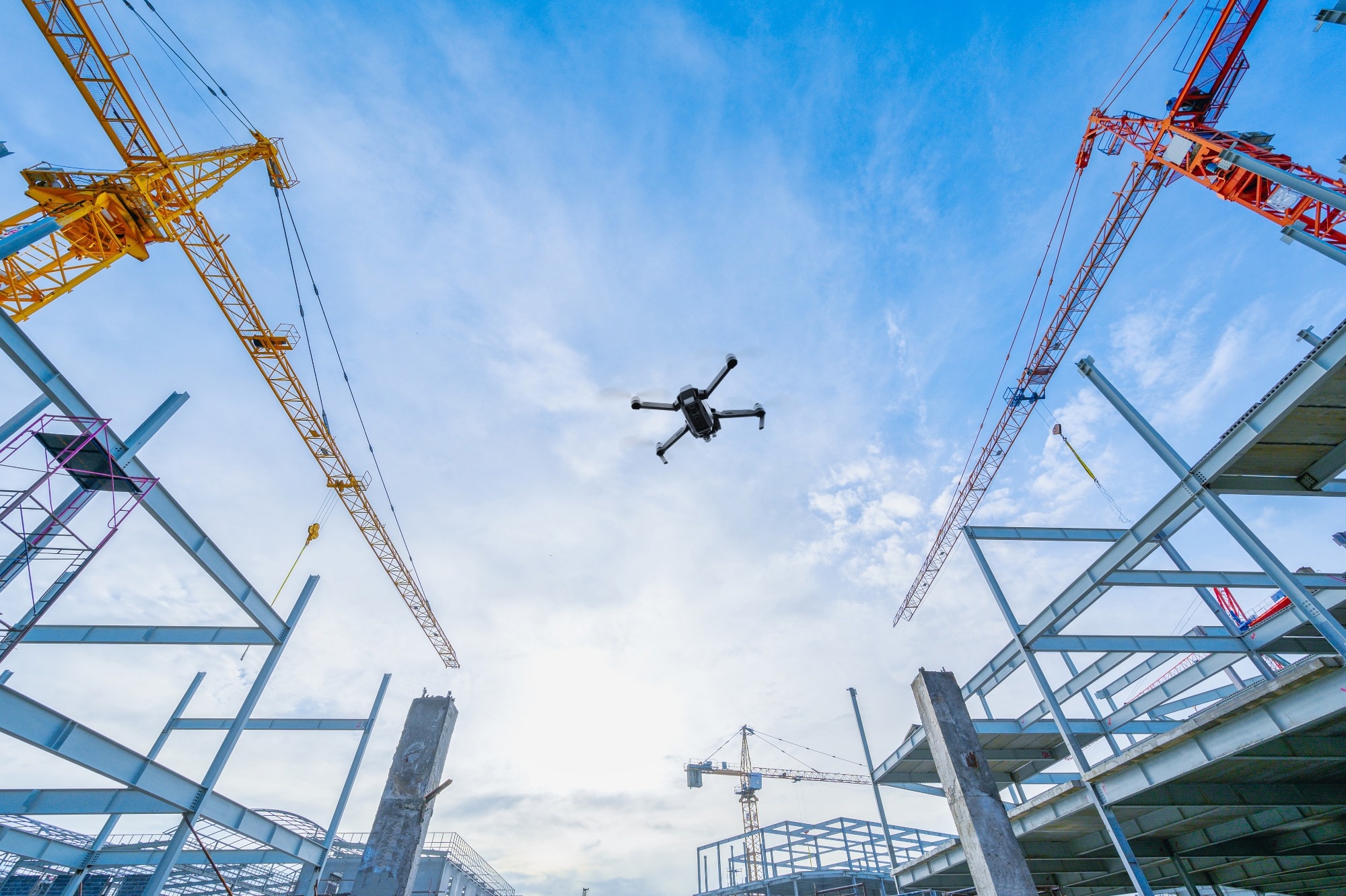 Drone flying over construction site.
