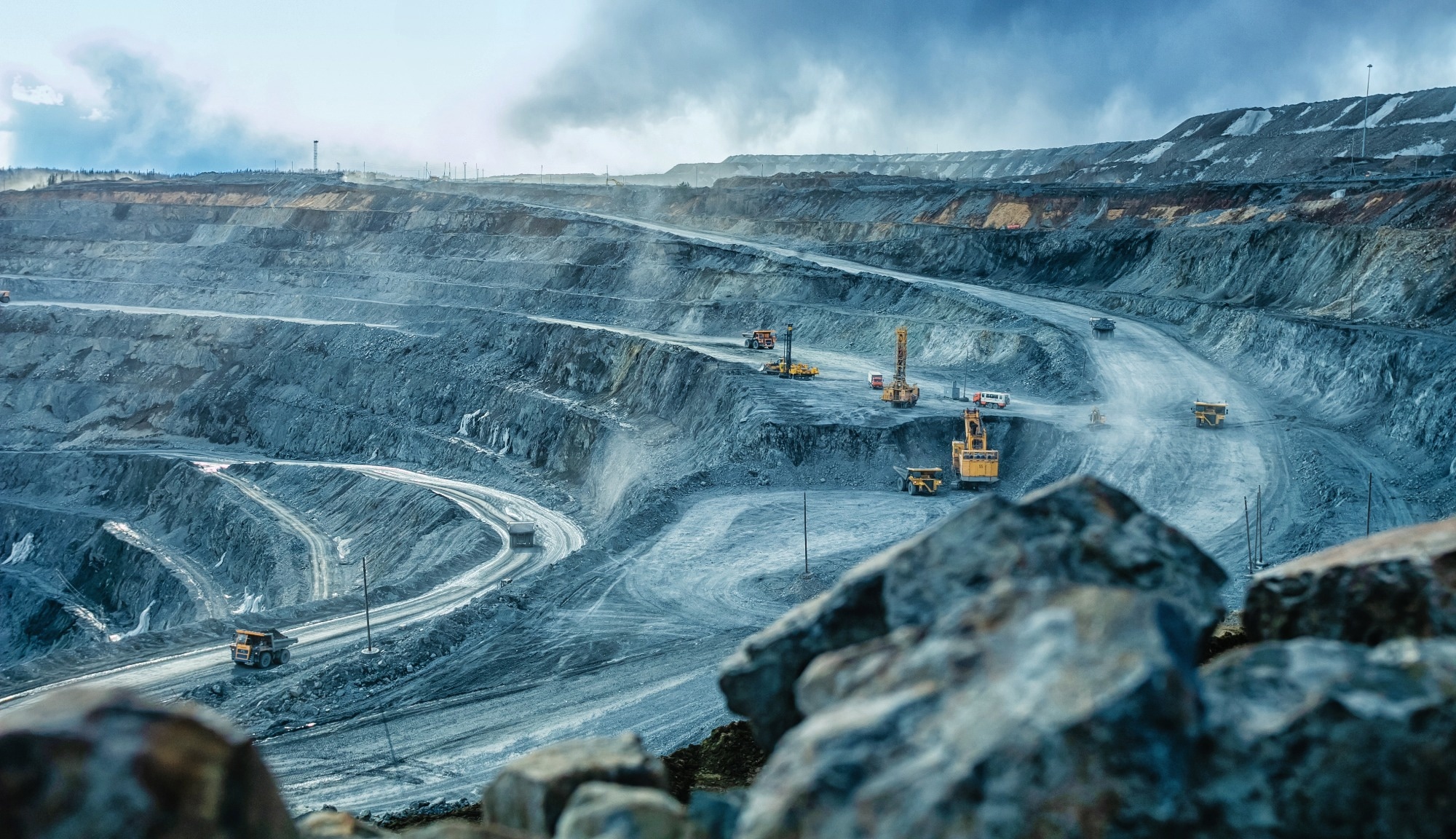 Work of trucks and the excavator in an open pit on Nickle mining.