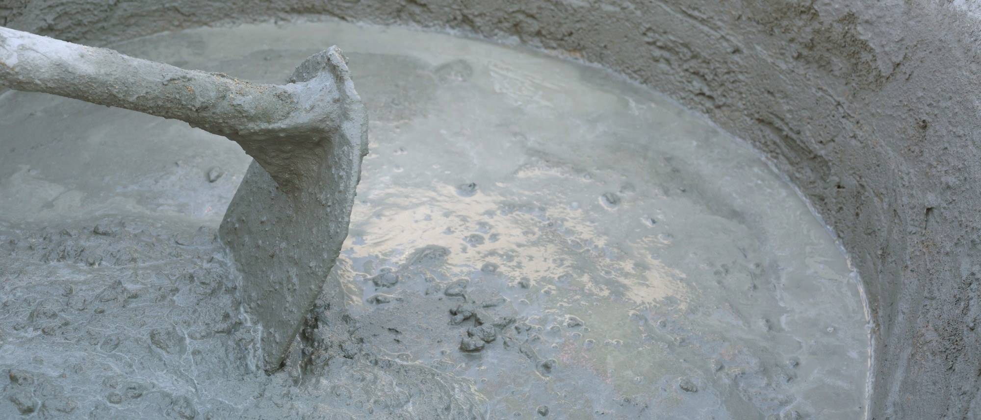A bucket of cement that is being mixed.