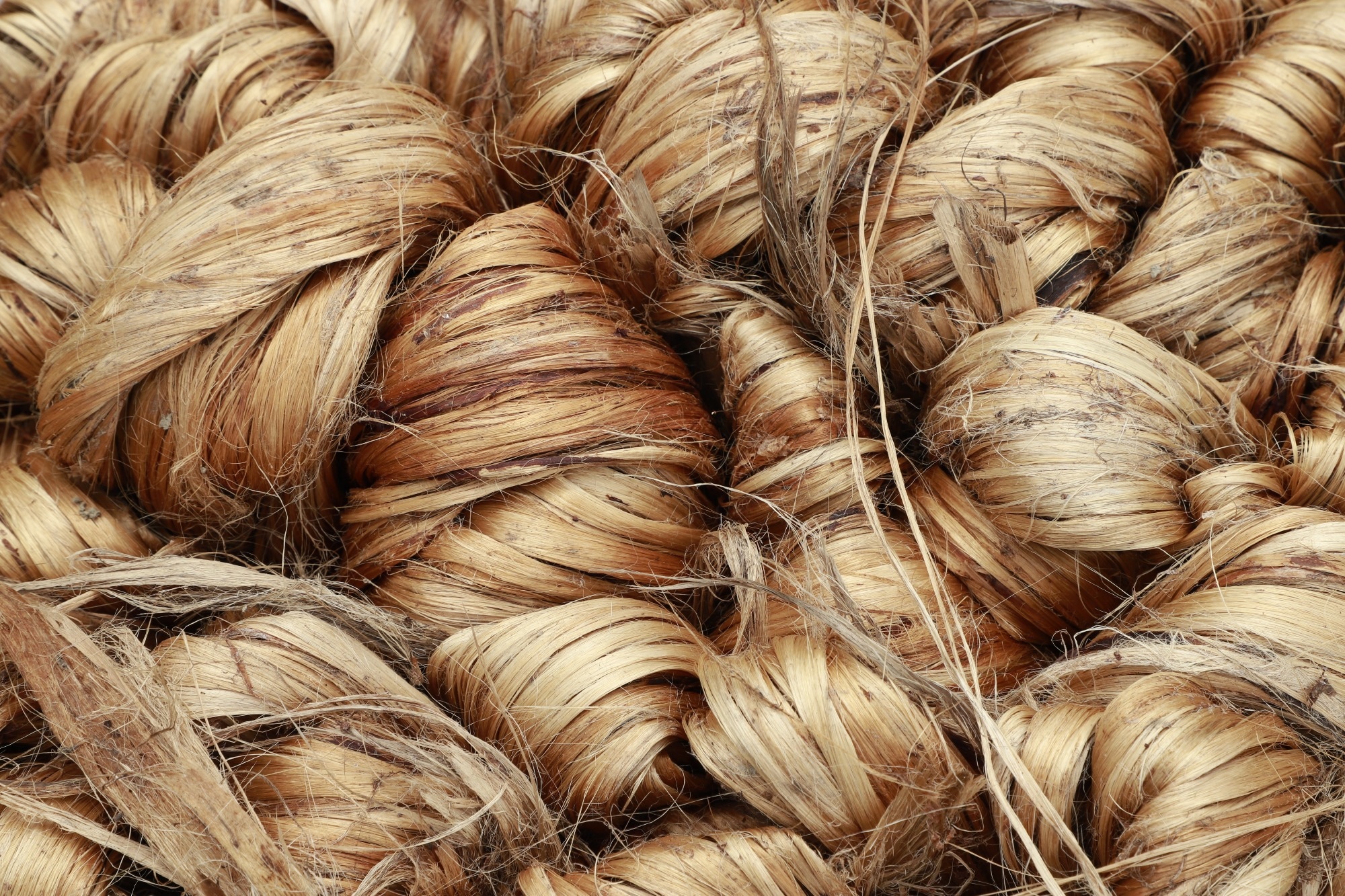 A thick brown bundle of raw jute fiber.