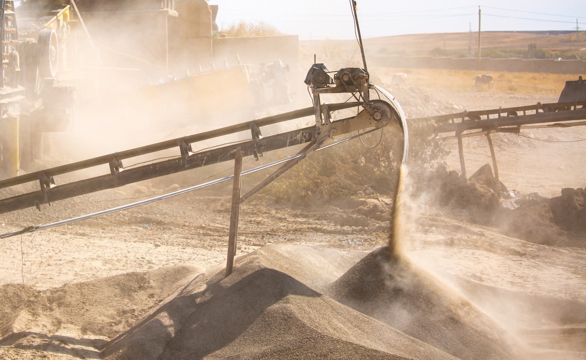 Vibrating screen stone crusher in operation. Crushing stones in a quarry for processing minerals, cement, limestone.