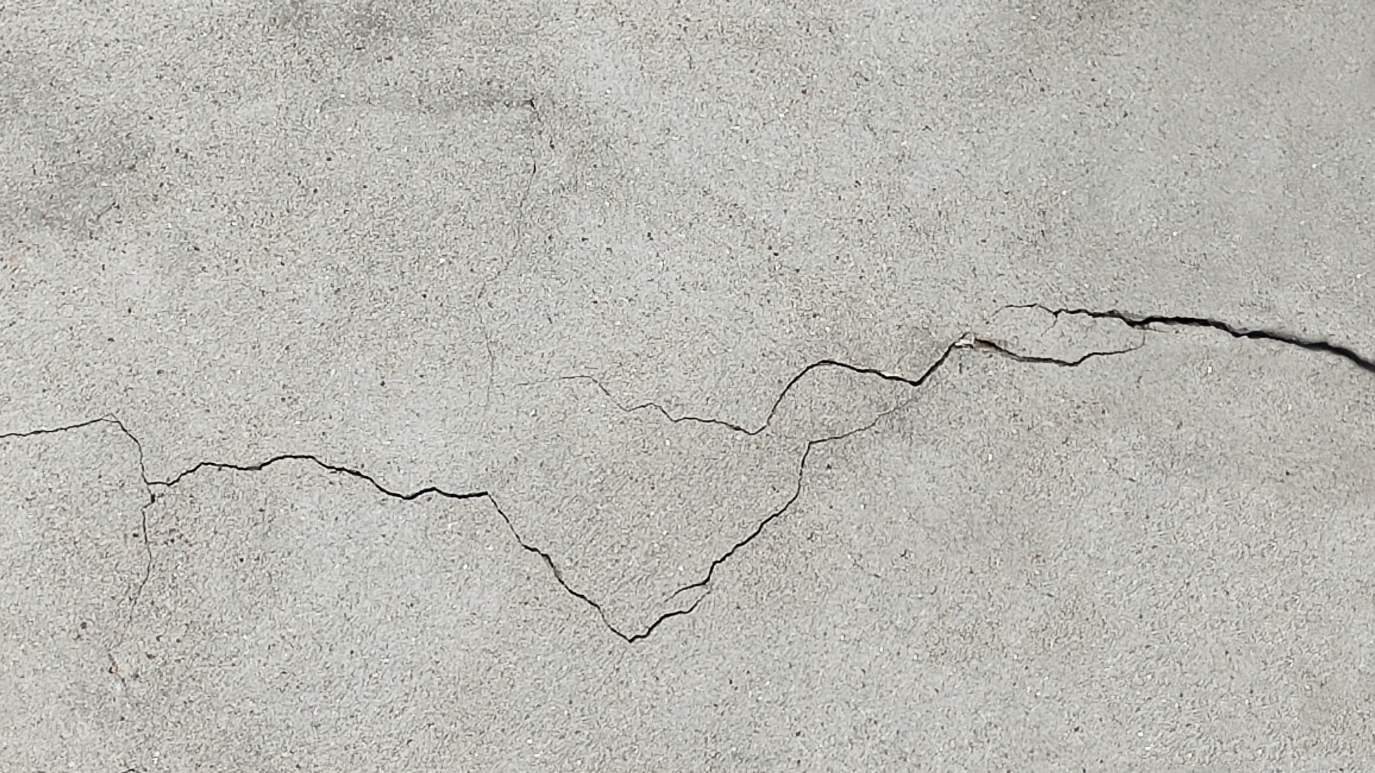 Cracked concrete surface.