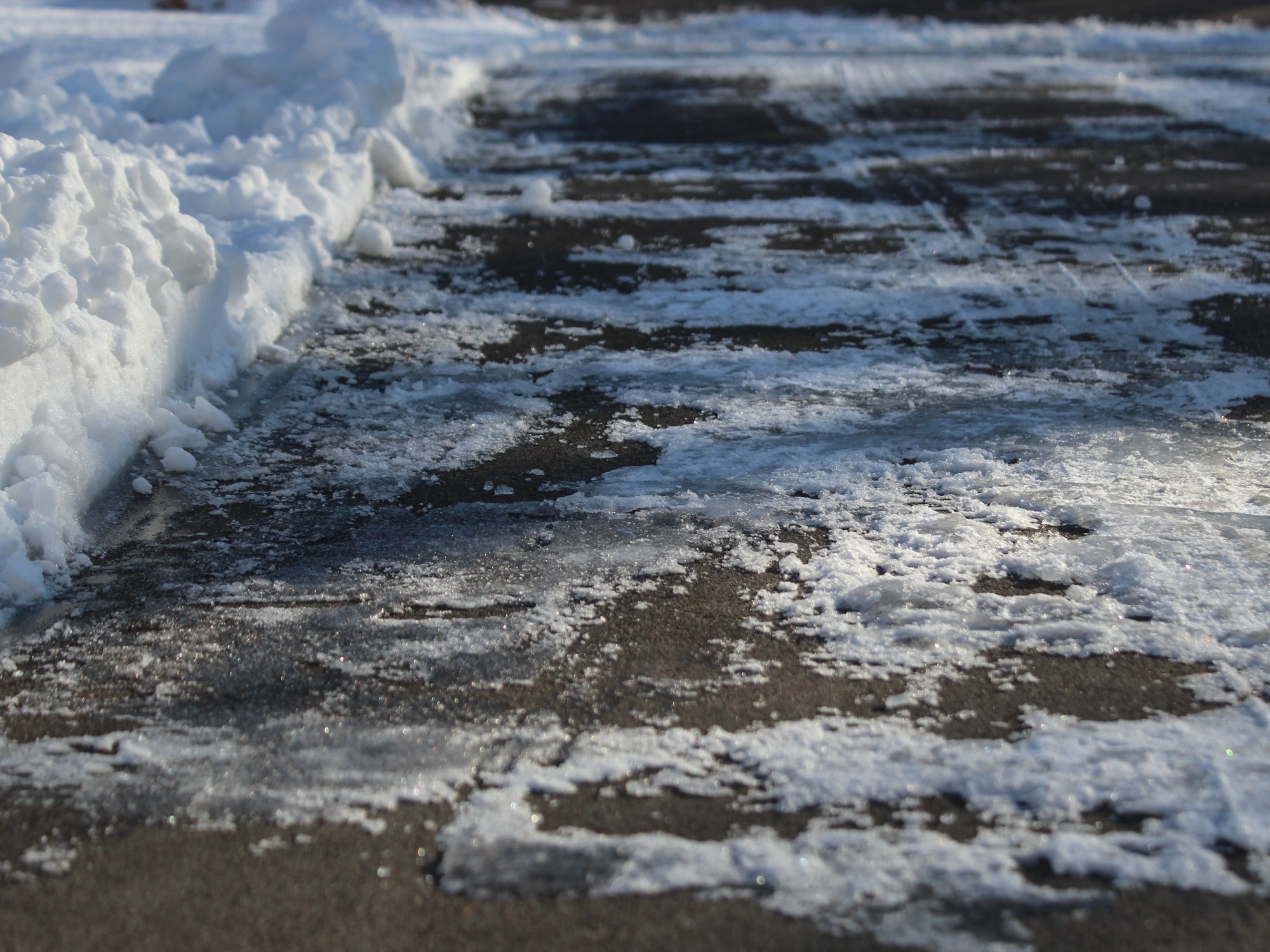 Low angle view of a driveway or concrete surface with frost covering it.
