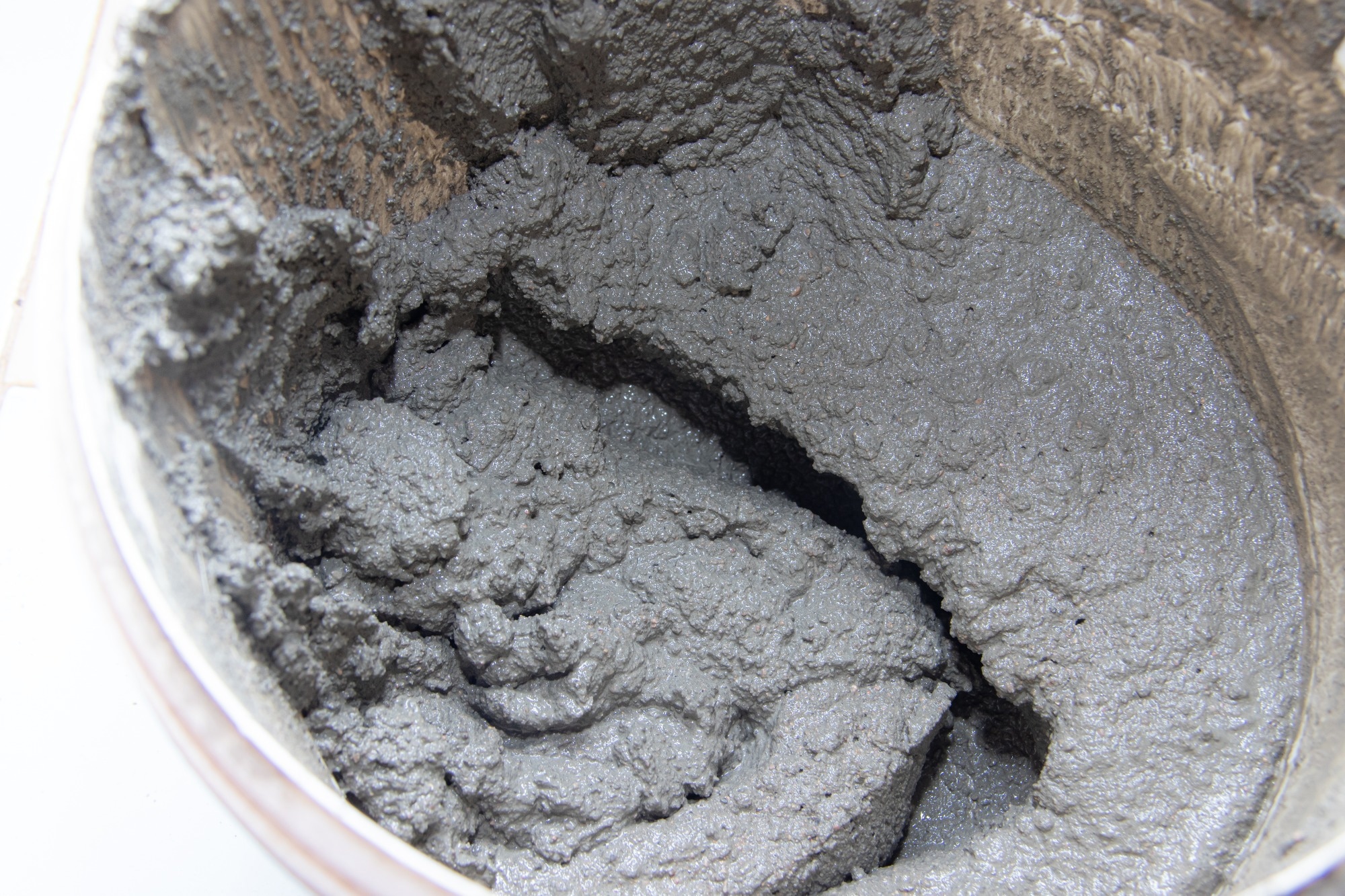 A bucket of freshly mixed concrete, close up shot.