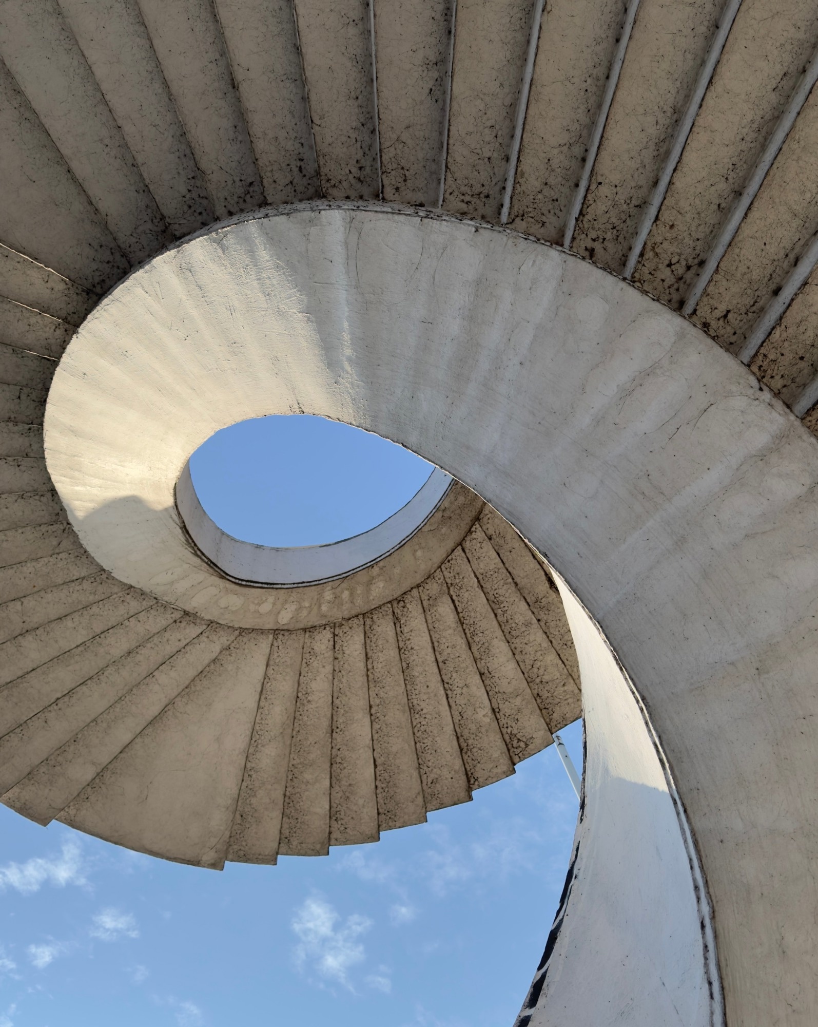 Modern curved concrete staircase from below