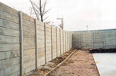Non-magnetic concrete security fencing erected around a test facility for sensitive electrical equipment.